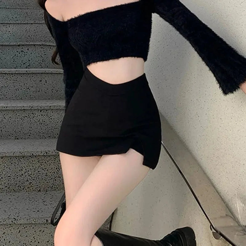 Model wearing the black asymmetric mini skirt beside a staircase