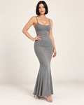 Model with a black bob wearing the grey Open-Back Bodycon Maxi Dress, composed expression and silver sandals